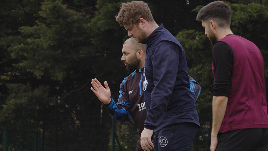 Three men participating in a coaching session